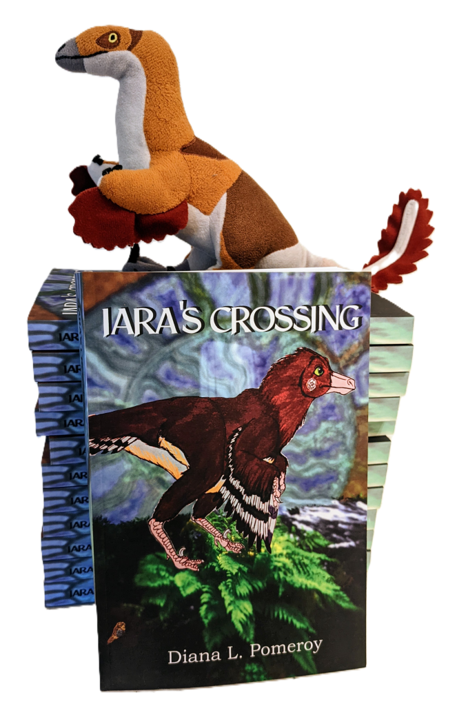 Plush Velociraptor named Iara sits atop the paperback novels Iara's Crossing [Indiegogo promo image]