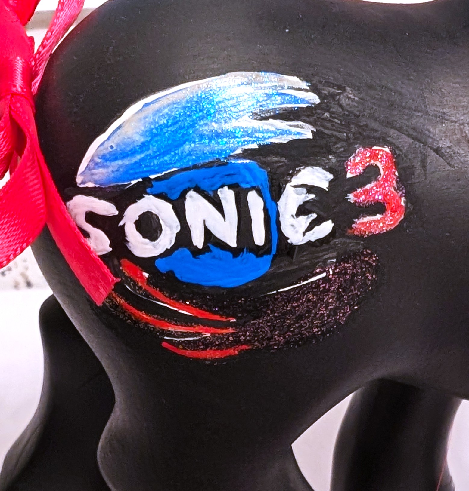 Closeup of Shadow movie pony symbols (Sonic Movie 3 logo)
