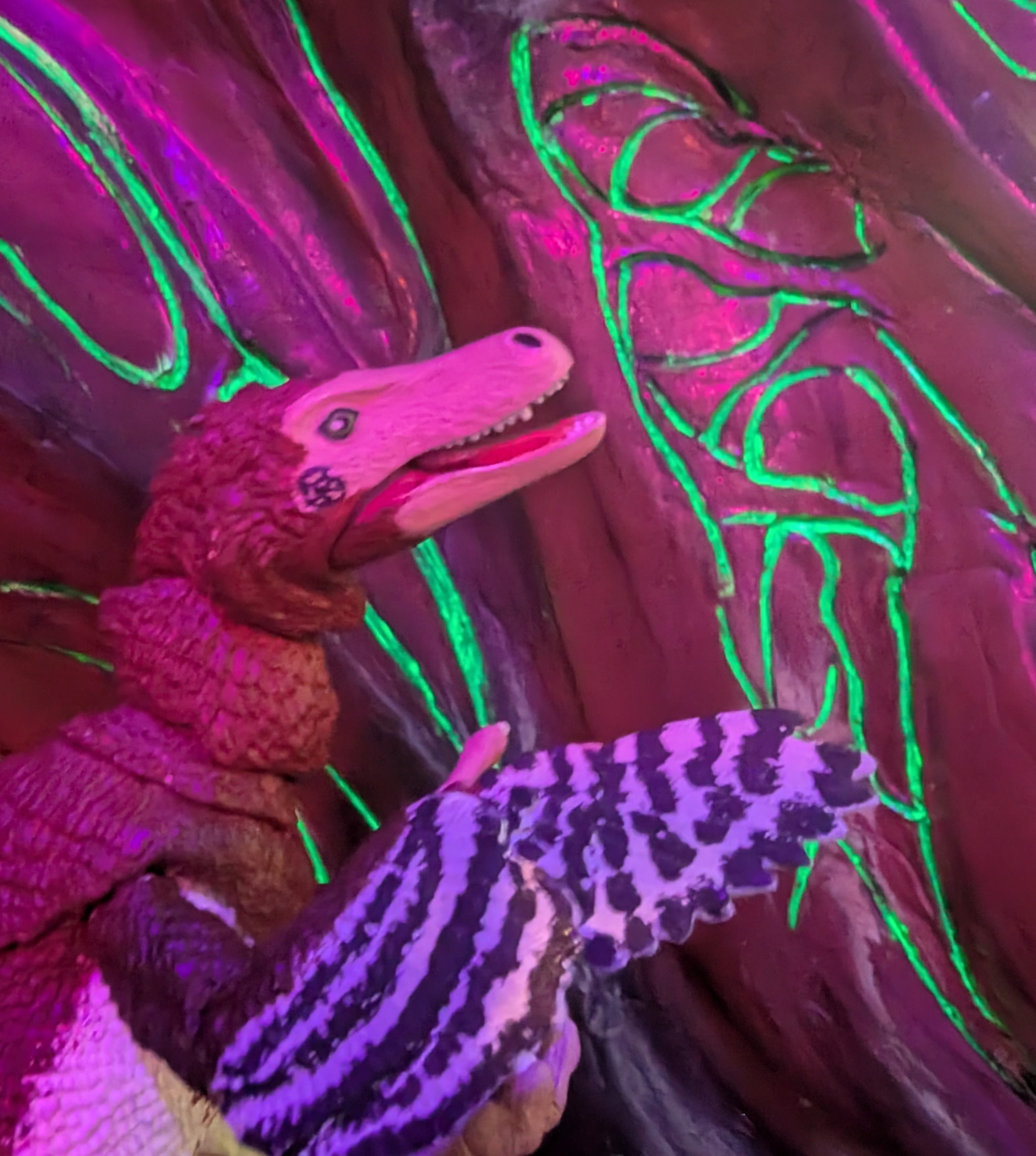 Iara stands by a cavern wall with strange glowing energy...